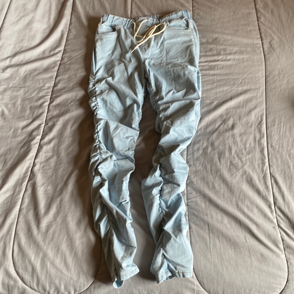 Brand: American Bazi. Size Medium. Light colored jeans.